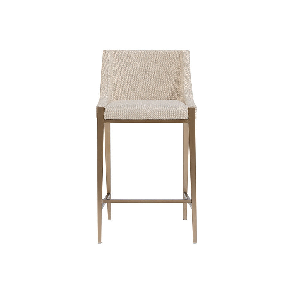 Dionne Counter Stool, shown in beige and antique brass with fabric, metal, and fixed low arms.