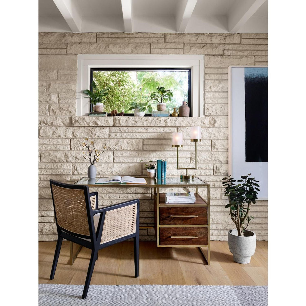 Four Hands Antonia Cane Dining Arm Chair with brushed ebony wood frame, natural cane and neutral upholstered seat