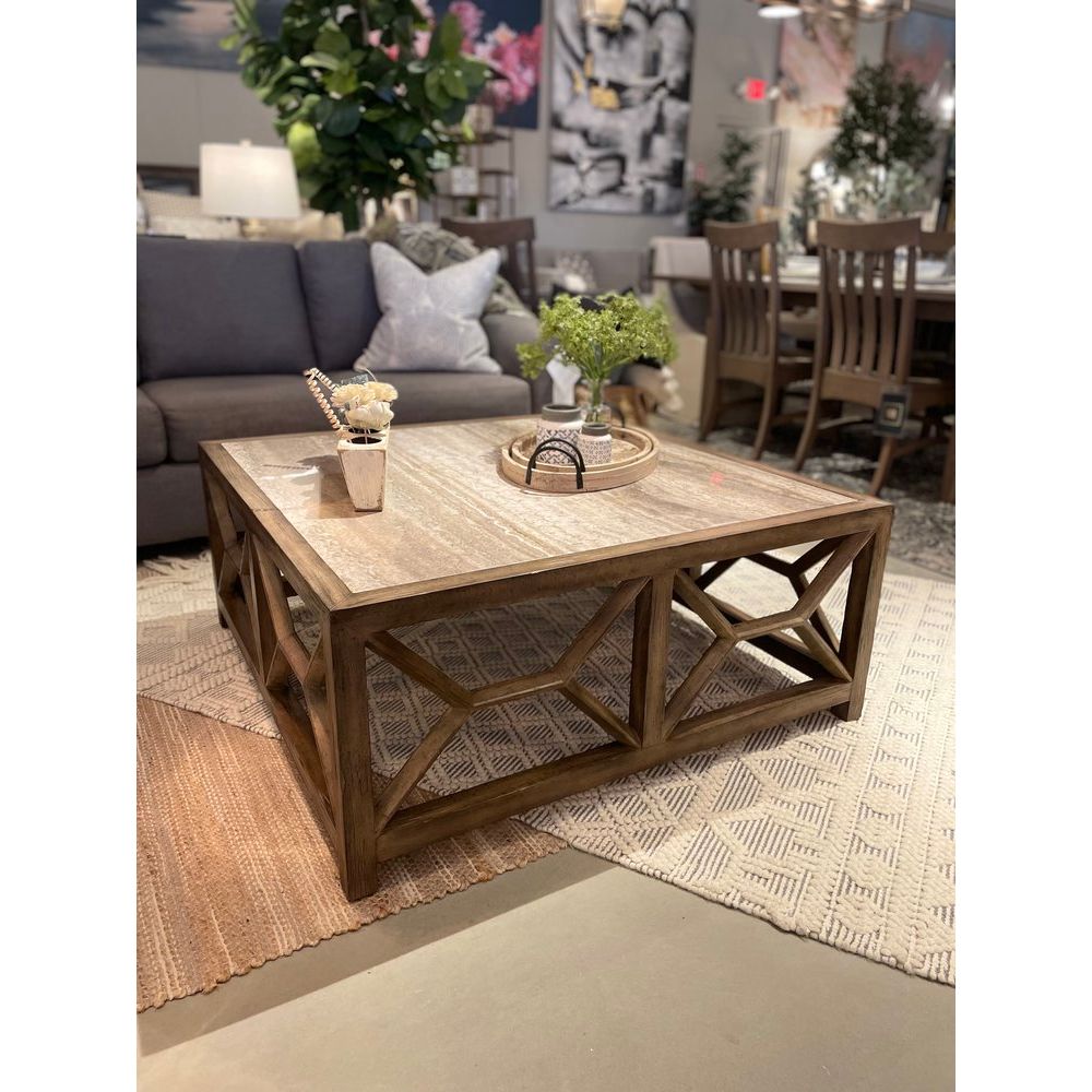 Sundance Square Coffee Table, shown in warm gray-brown and weathered taupe with wood and a open lattice apron base.