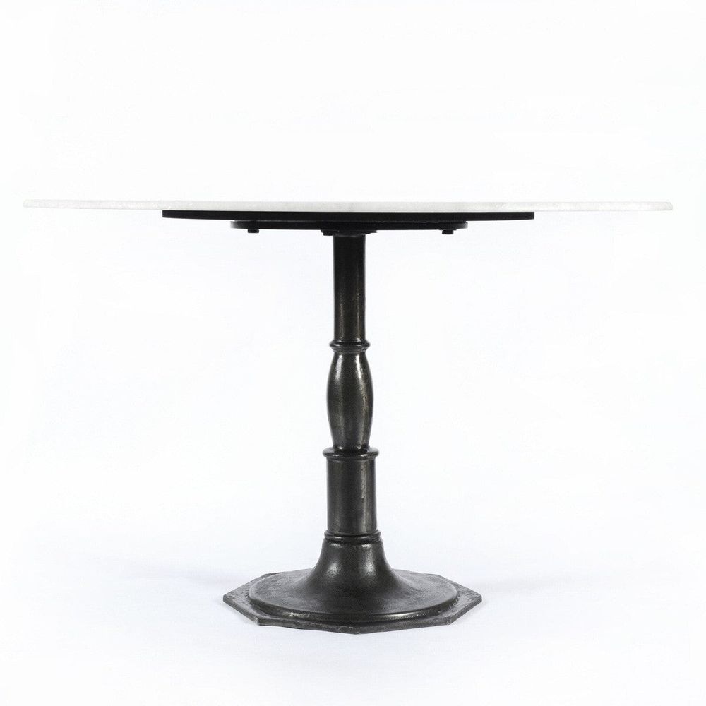Aiden Round Dining Table, shown in white and charcoal black with marble, cast iron, and a single pedestal base.
