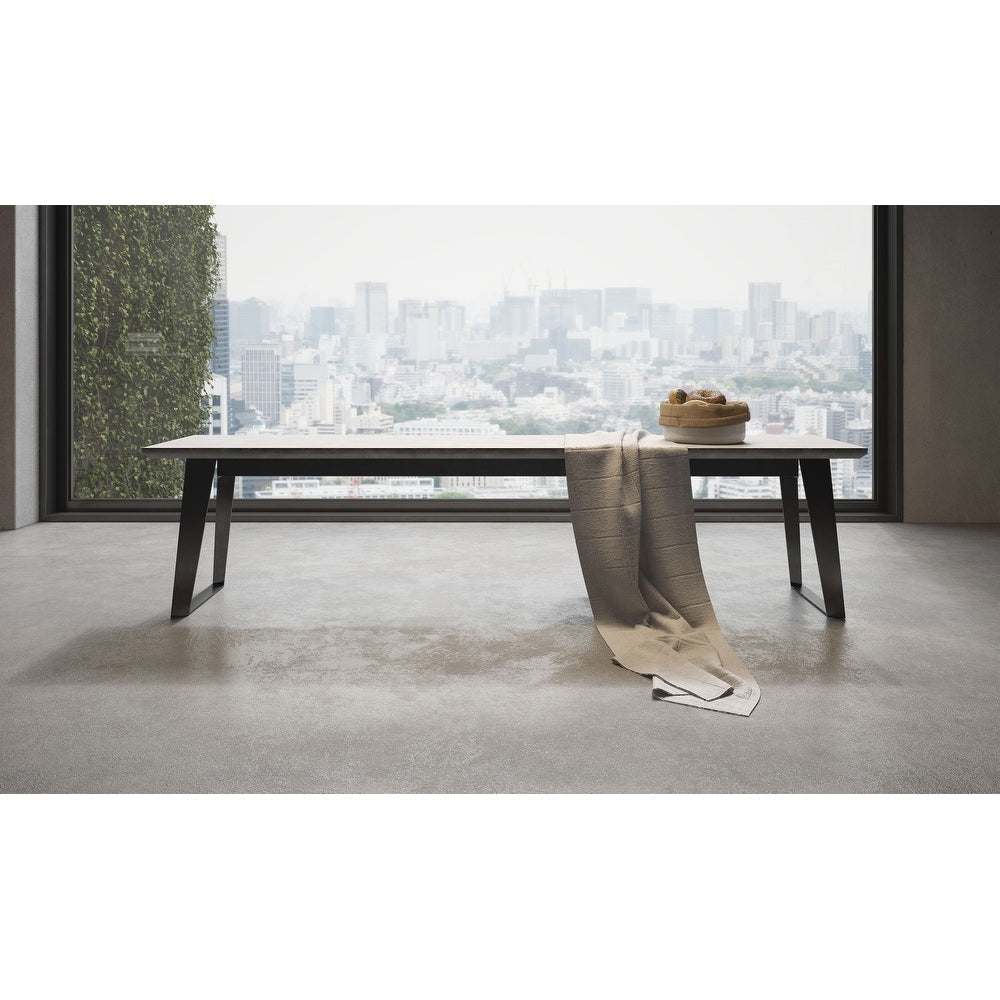 Amsterdam Bench in gray concrete with black angled metal legs, three-quarter view